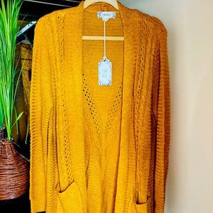 New, cozy and elegant knitted cardigan.